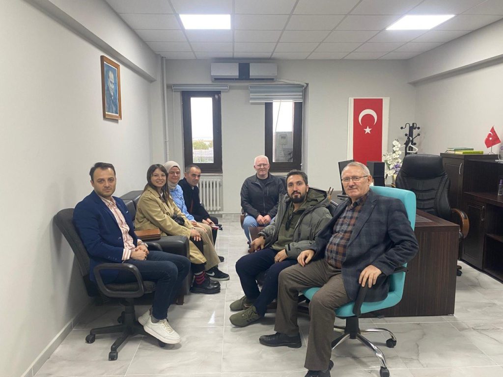 Görselde 6 kişi (2 kadın 4 erkek) U biçiminde sandalyelerde oturuyor